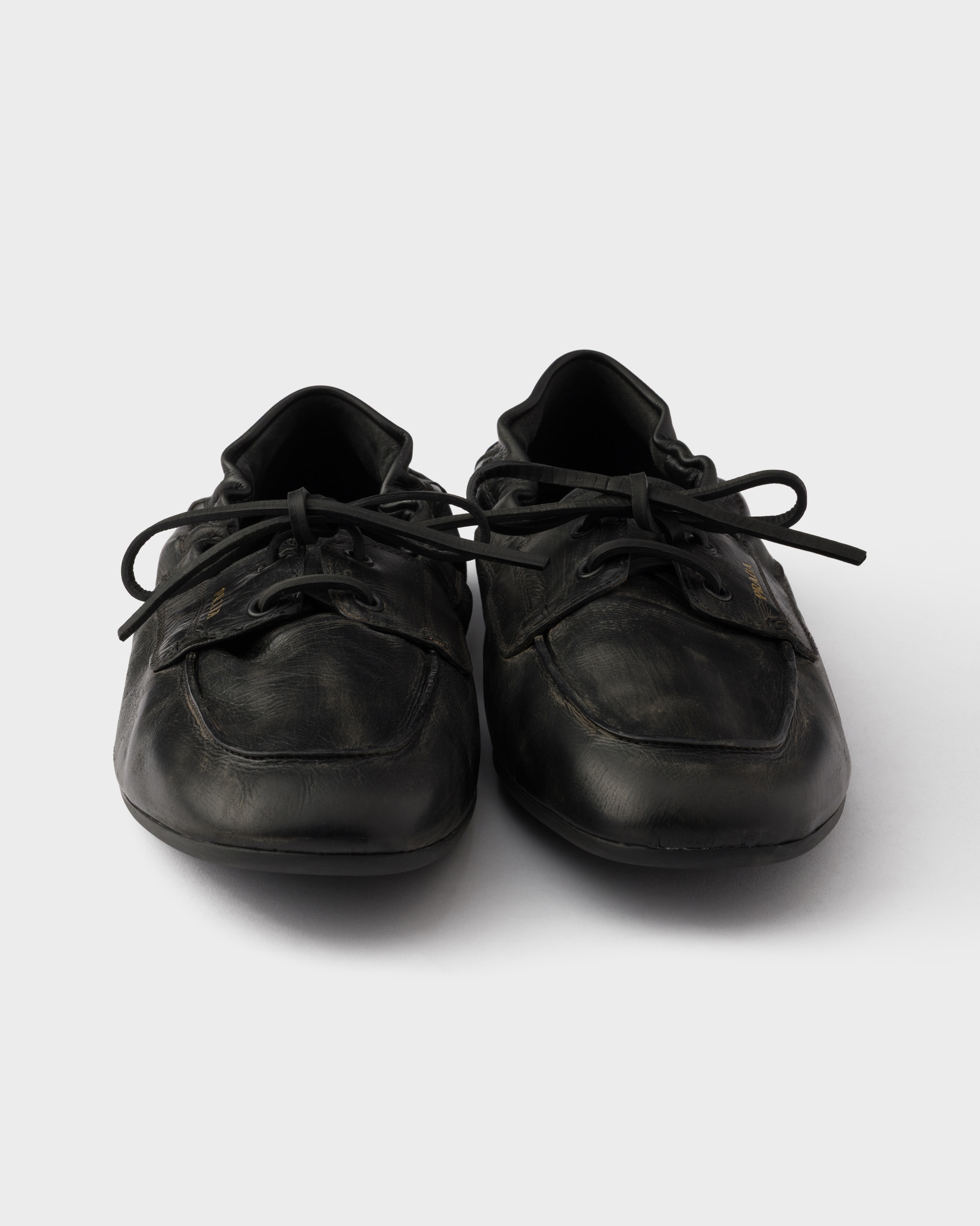 Black Shuffle antiqued leather boat shoes | PRADA - United States