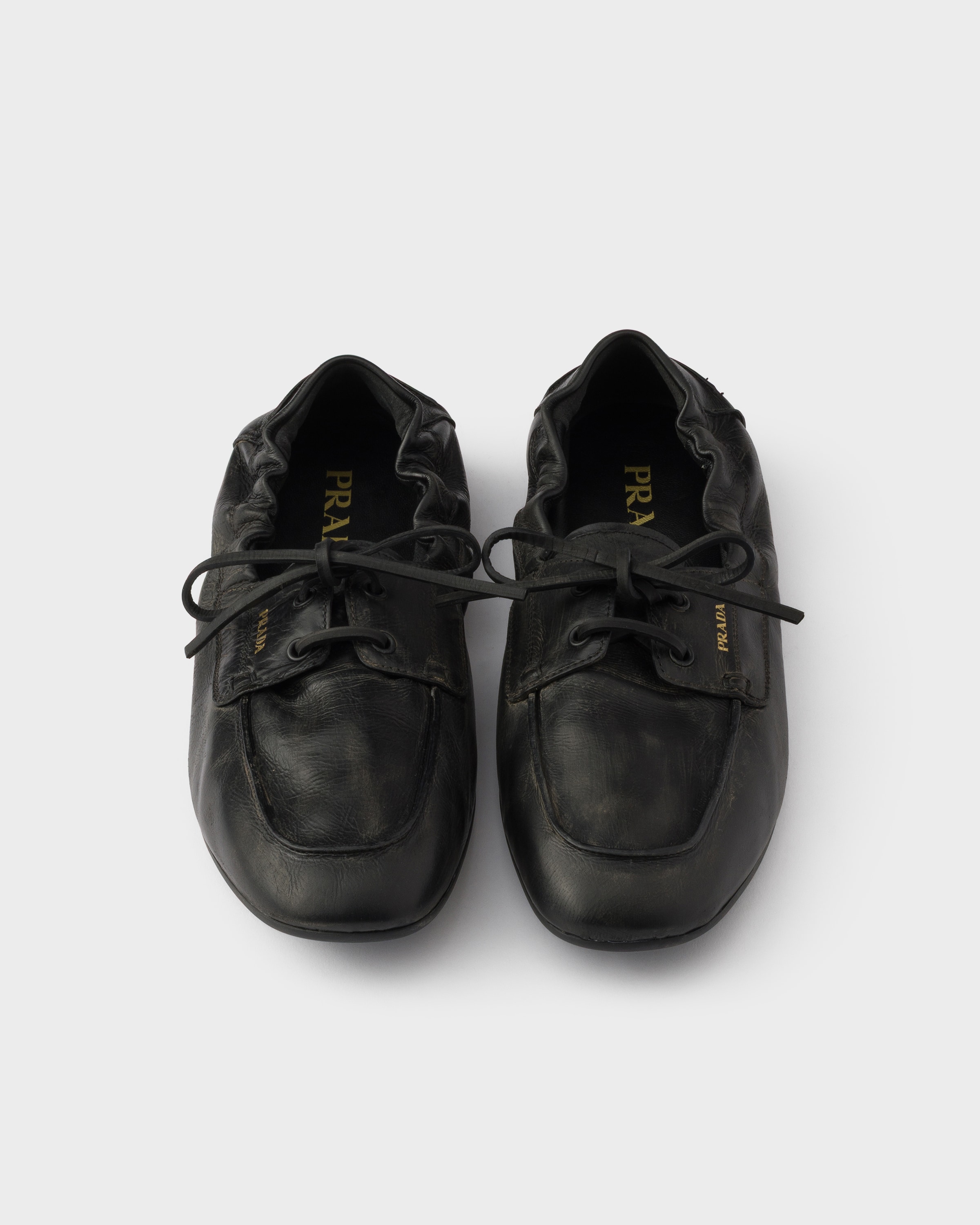 Black Shuffle antiqued leather boat shoes | PRADA - United States