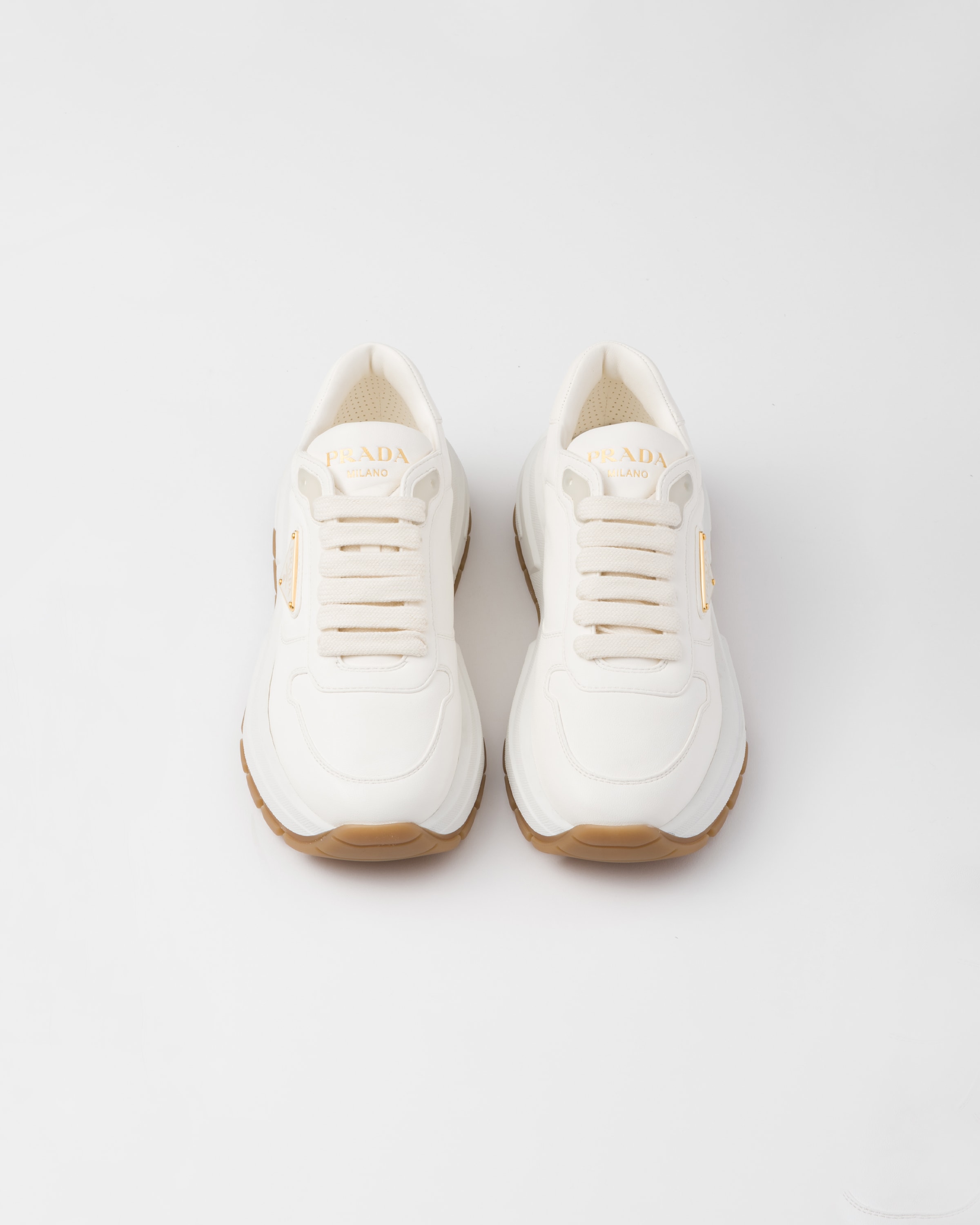 Shop Prada Leather Sneakers In Elfenbein