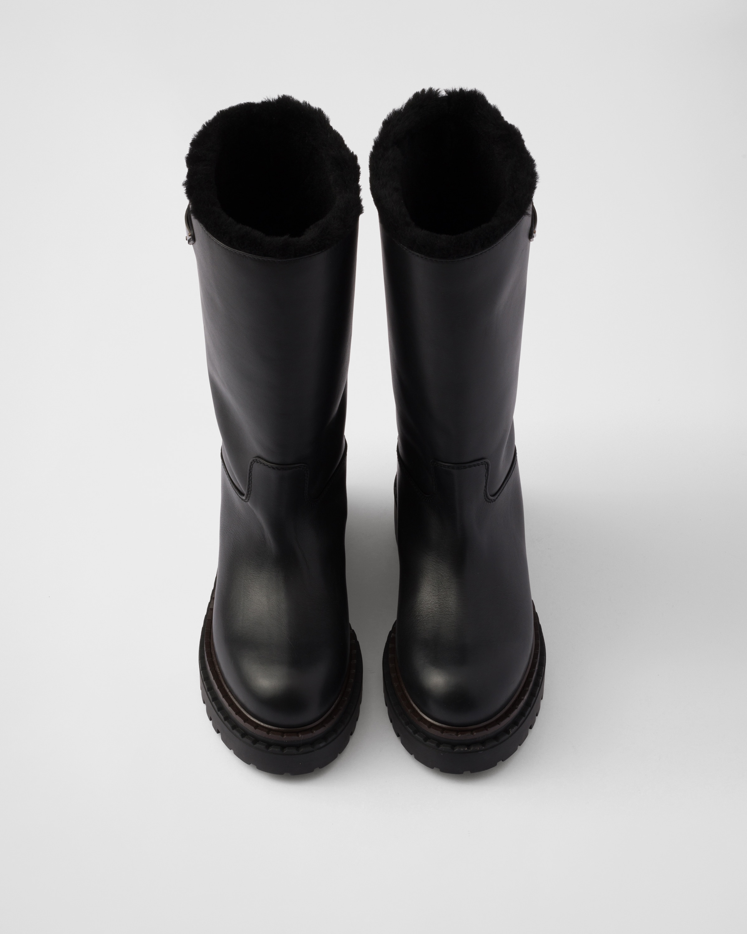 Prada Leather And Shearling Boots In Black