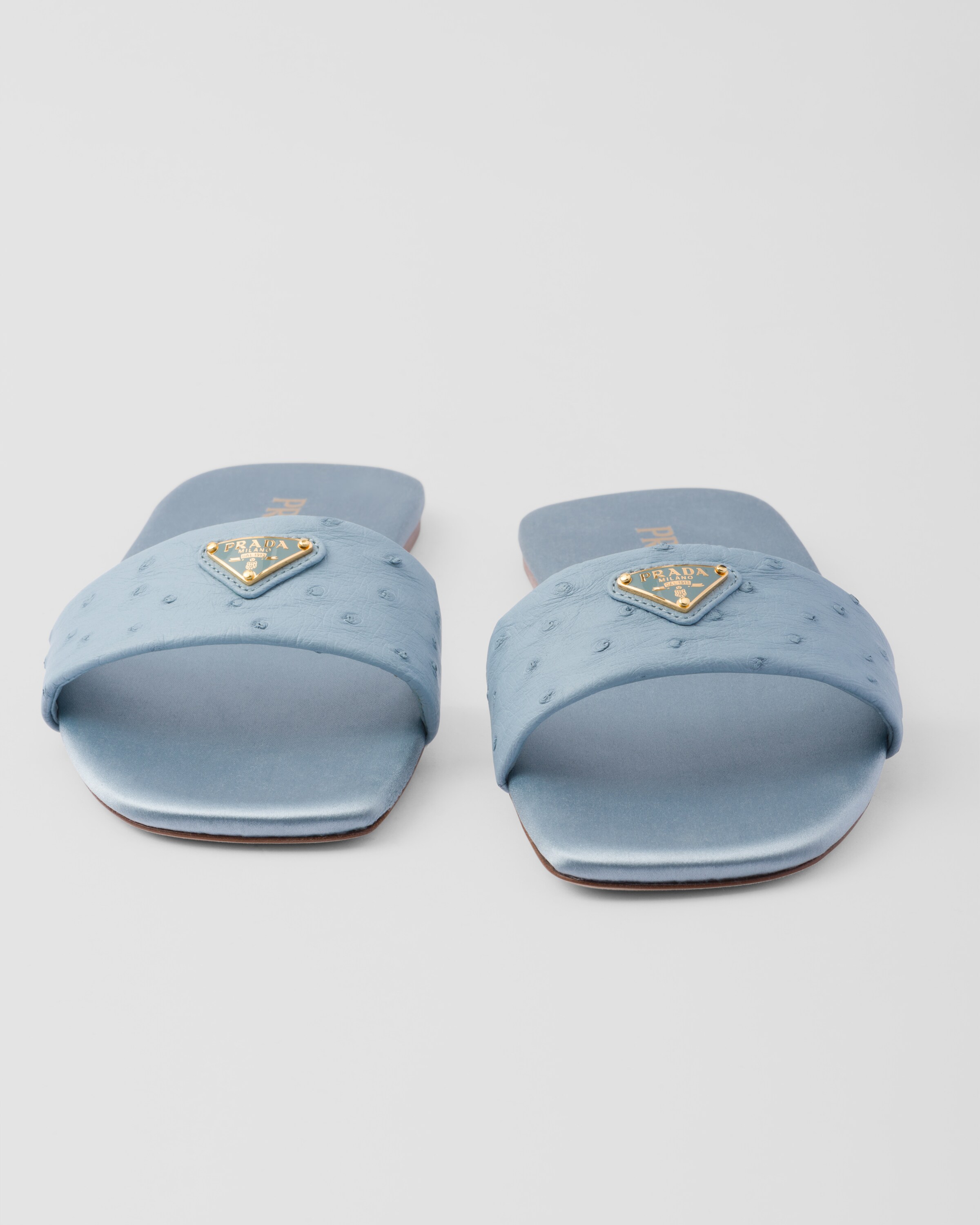 サンダル・ミュール Prada Light Blue Leather Slippers Leather-trimmed PVC mules in blue - Prada | Mytheresa