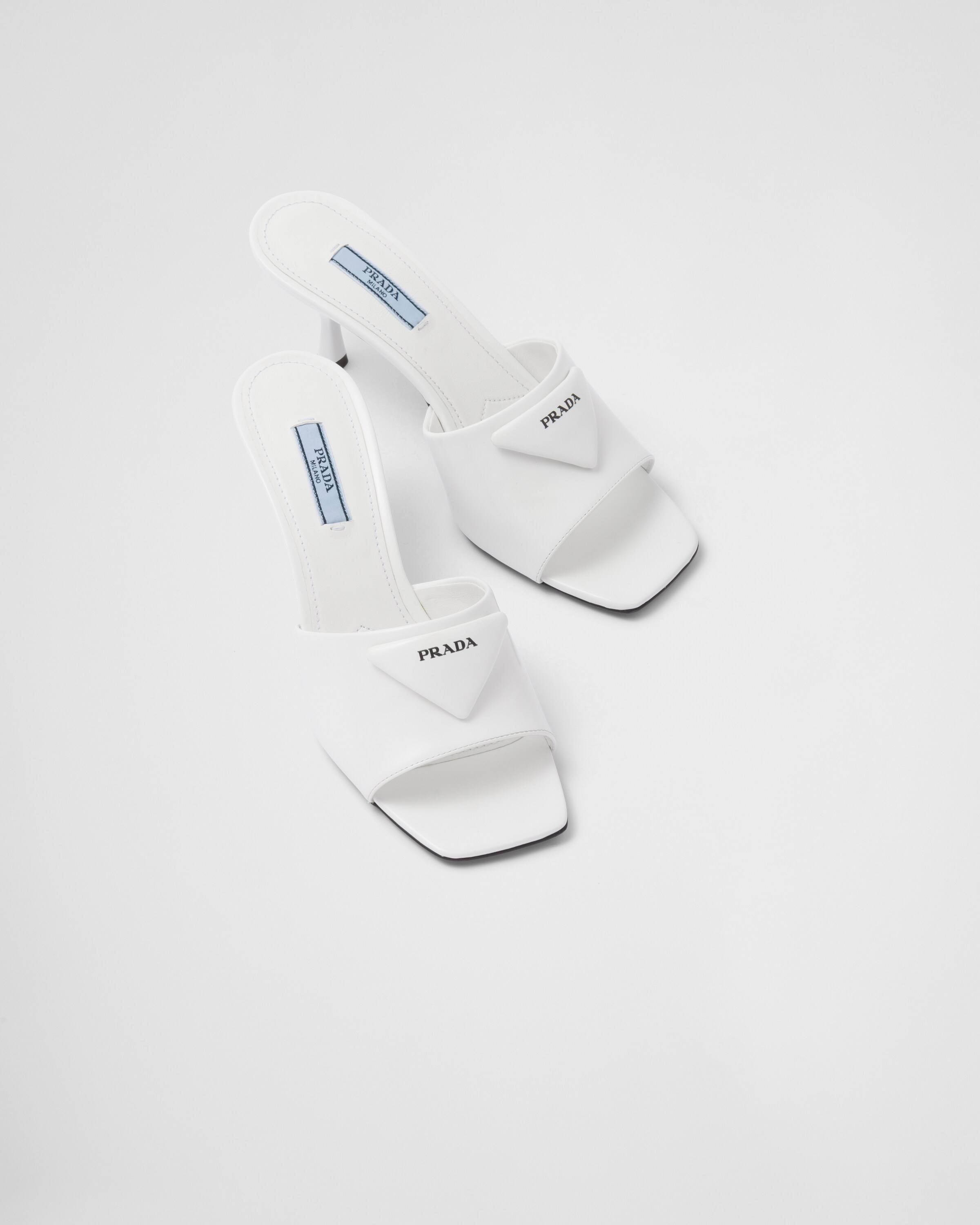 White Brushed leather heeled slides | Prada