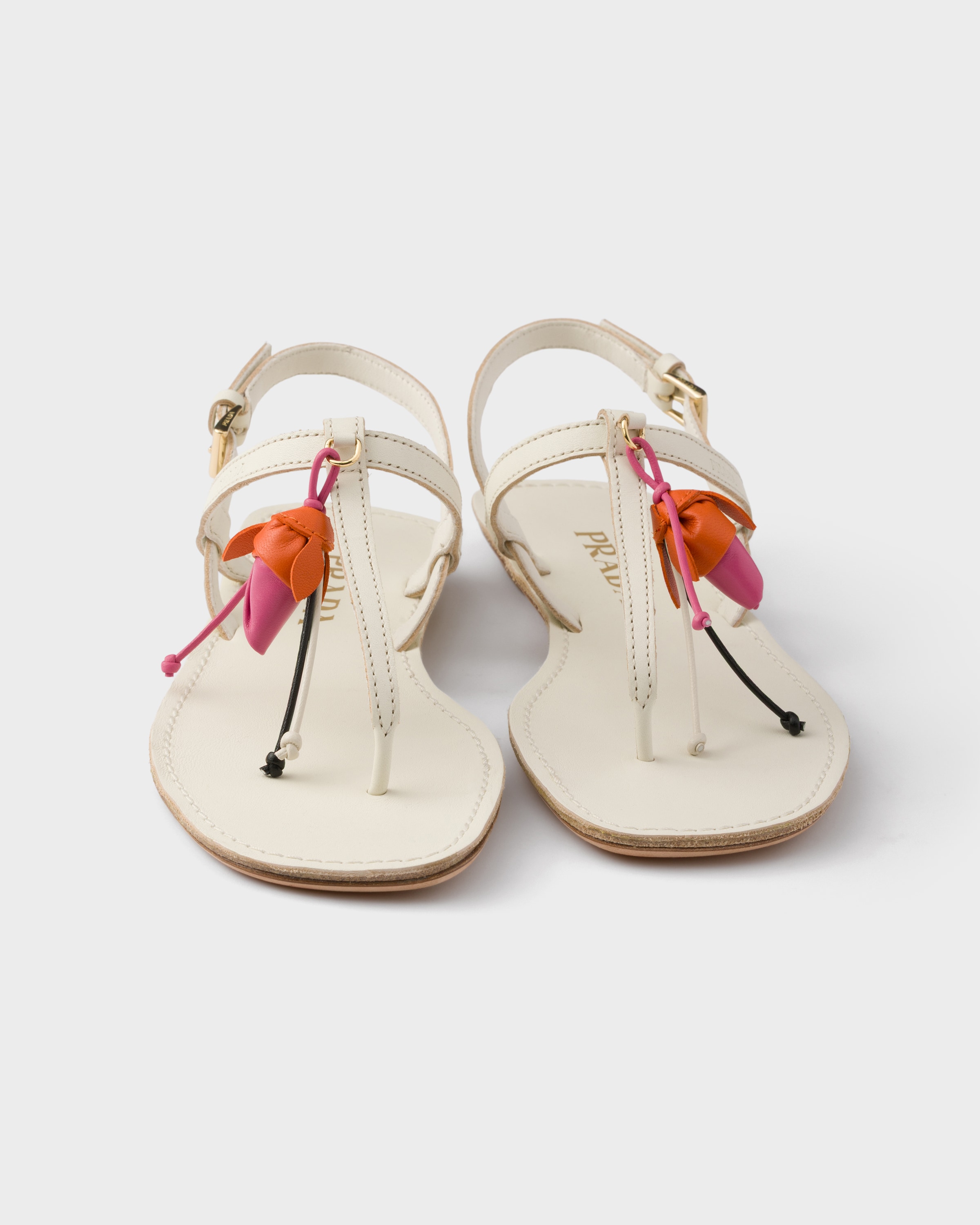 Chalk White Antiqued leather thong sandals with floral ornament