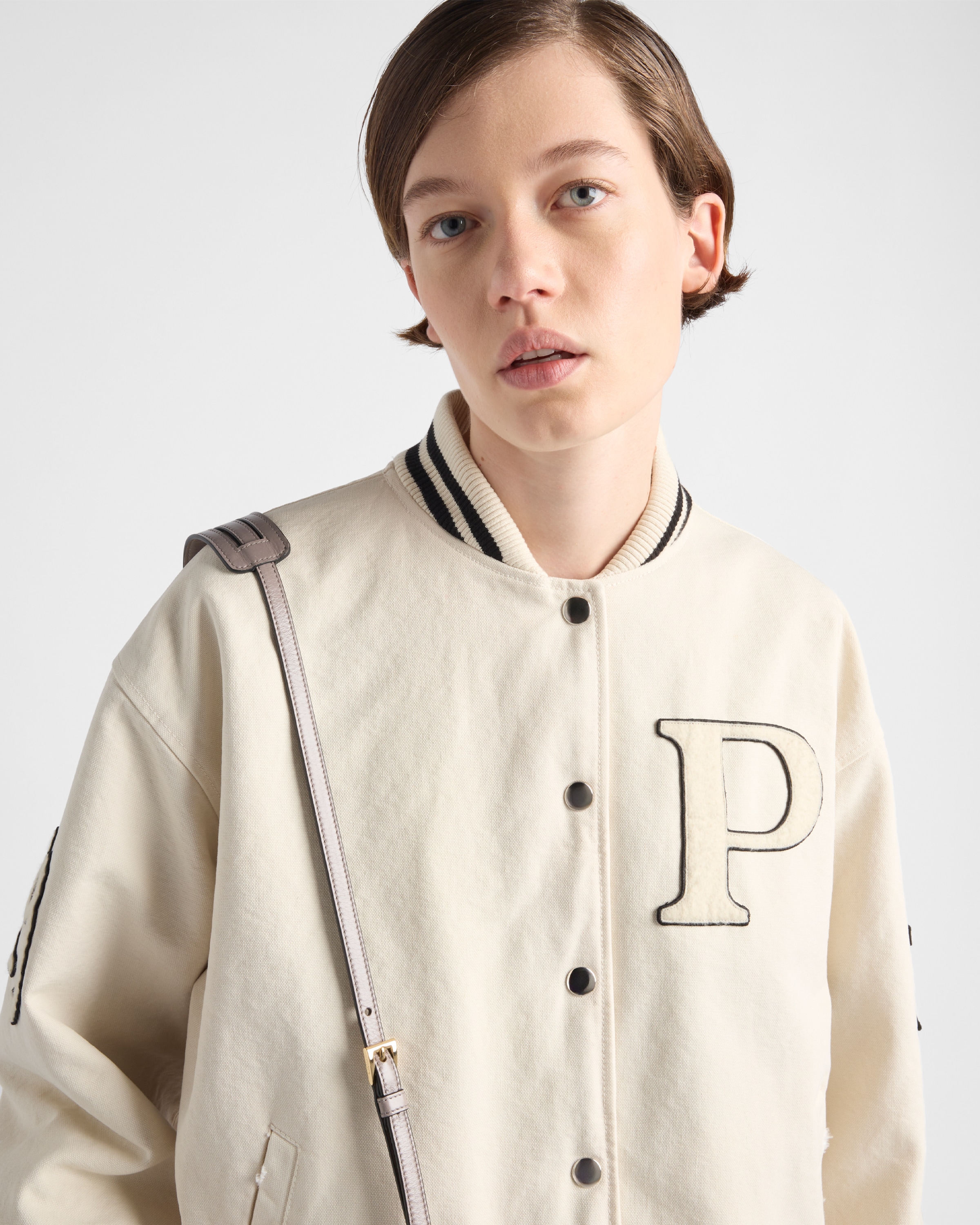 Shop Prada Bomberjacke Aus Canvas Mit Aufnähern In Elfenbein