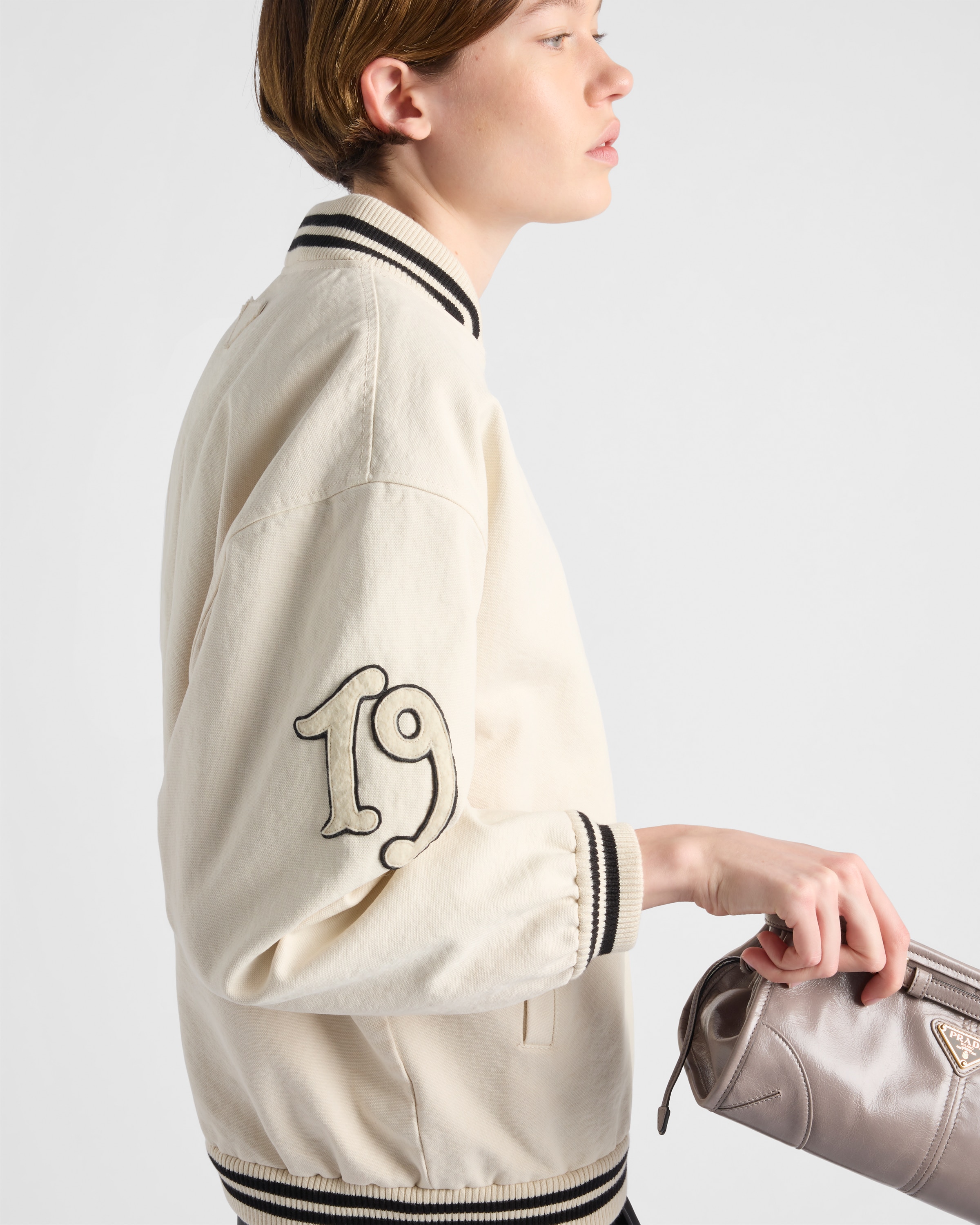 Shop Prada Bomberjacke Aus Canvas Mit Aufnähern In Elfenbein