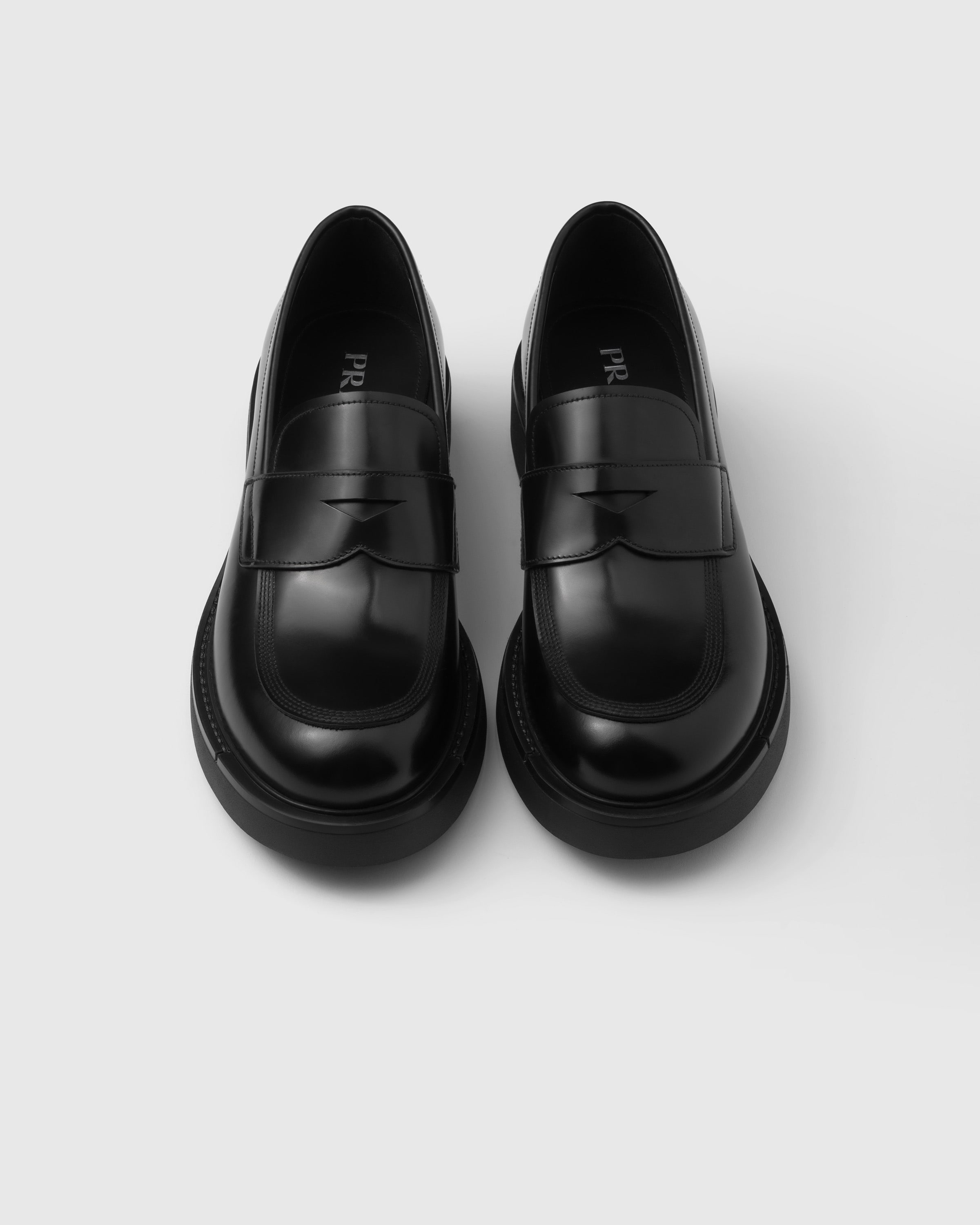 Shop Prada Brushed Leather Loafers In Black