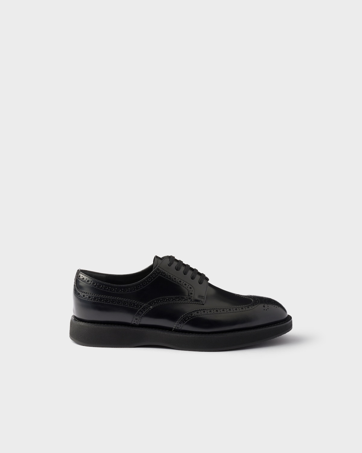 PRADA 26S BROGUE SHOES IN BLACK PATENT CALFSKIN