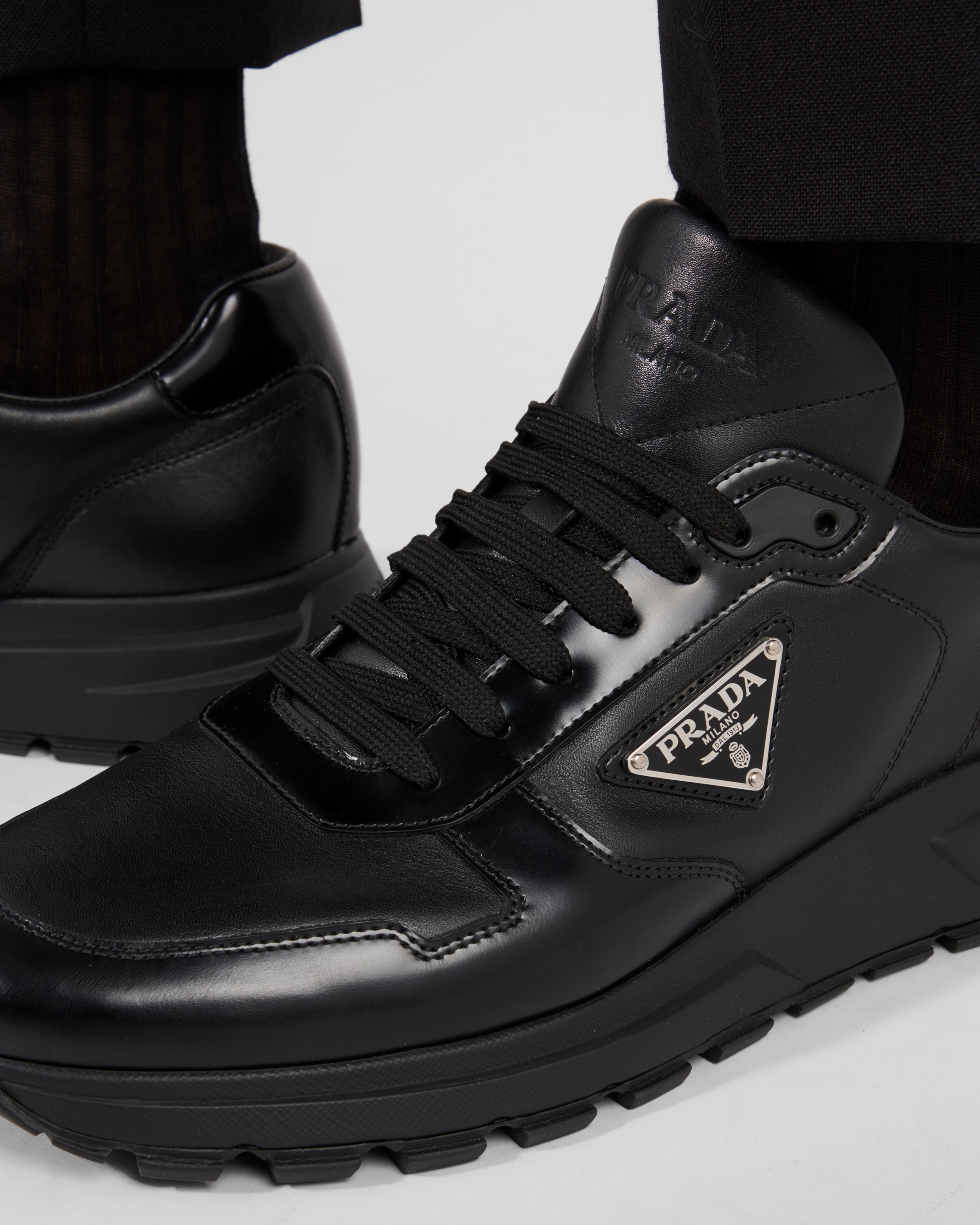 Shop Prada Leather Sneakers In Black