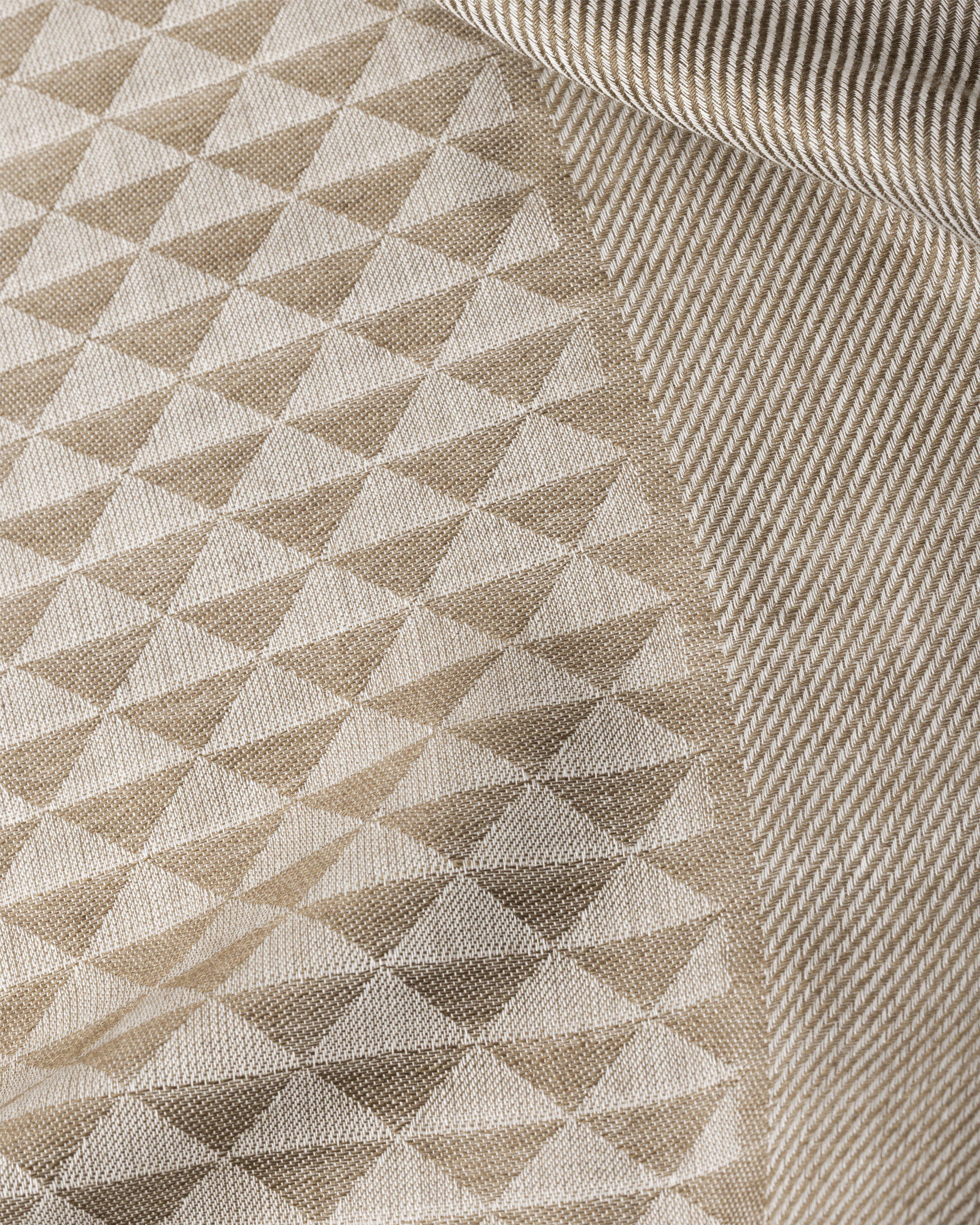 Close-up of scarf fabric showing geometric repeating triangle pattern