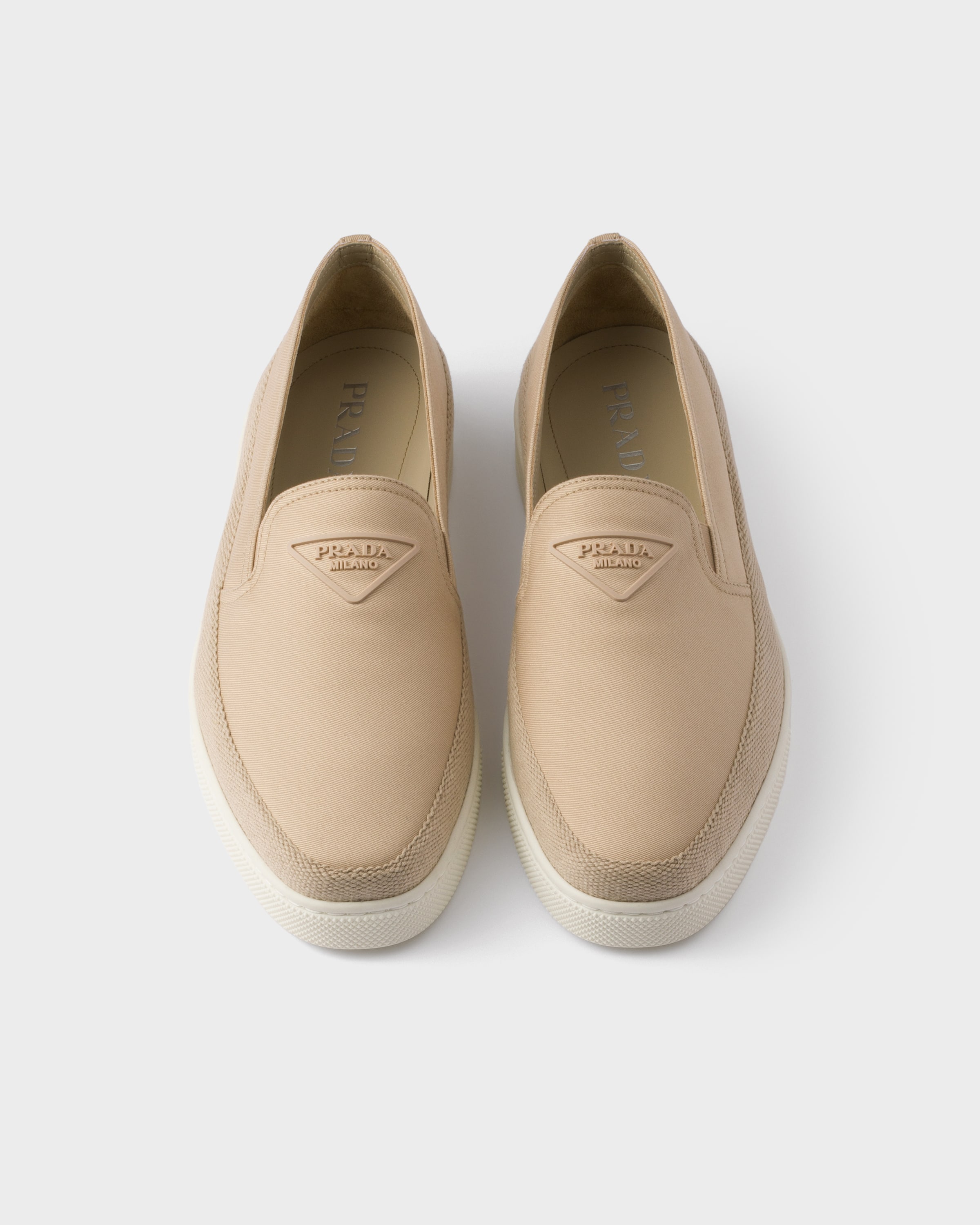 Prada Embossed-logo Slip-on Loafers In Neutral