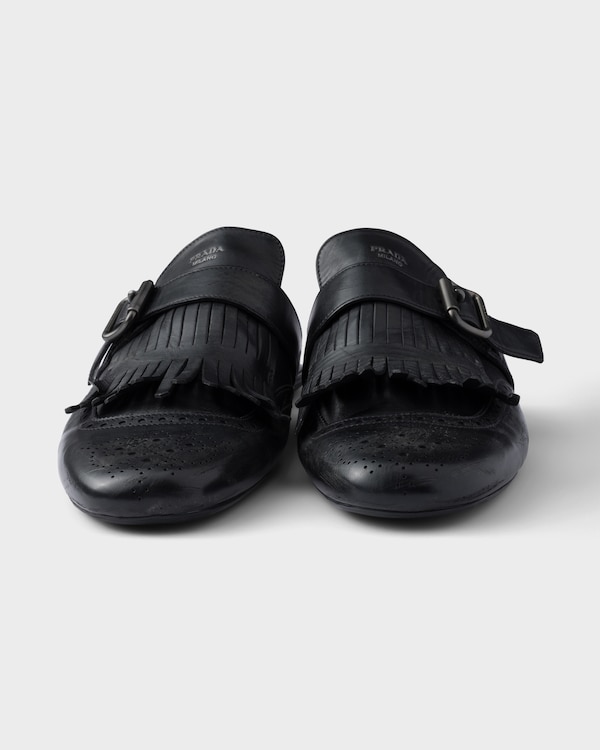 Shuffle antiqued leather mules with buckled strap and fringe Shuffle antiqued leather mules with buckled strap and fringe