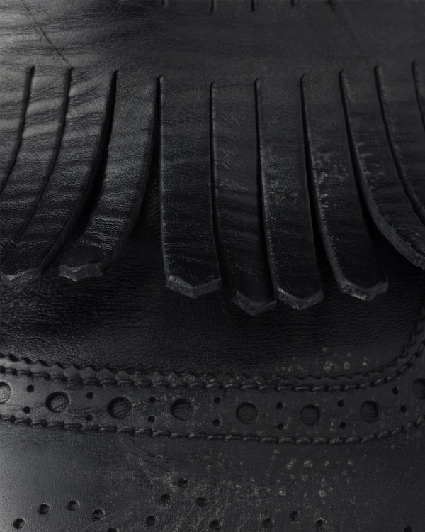 Shuffle antiqued leather mules with buckled strap and fringe Shuffle antiqued leather mules with buckled strap and fringe