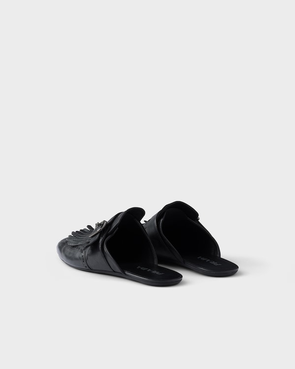 Shuffle antiqued leather mules with buckled strap and fringe Shuffle antiqued leather mules with buckled strap and fringe