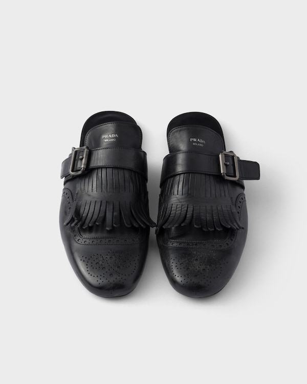 Shuffle antiqued leather mules with buckled strap and fringe Shuffle antiqued leather mules with buckled strap and fringe