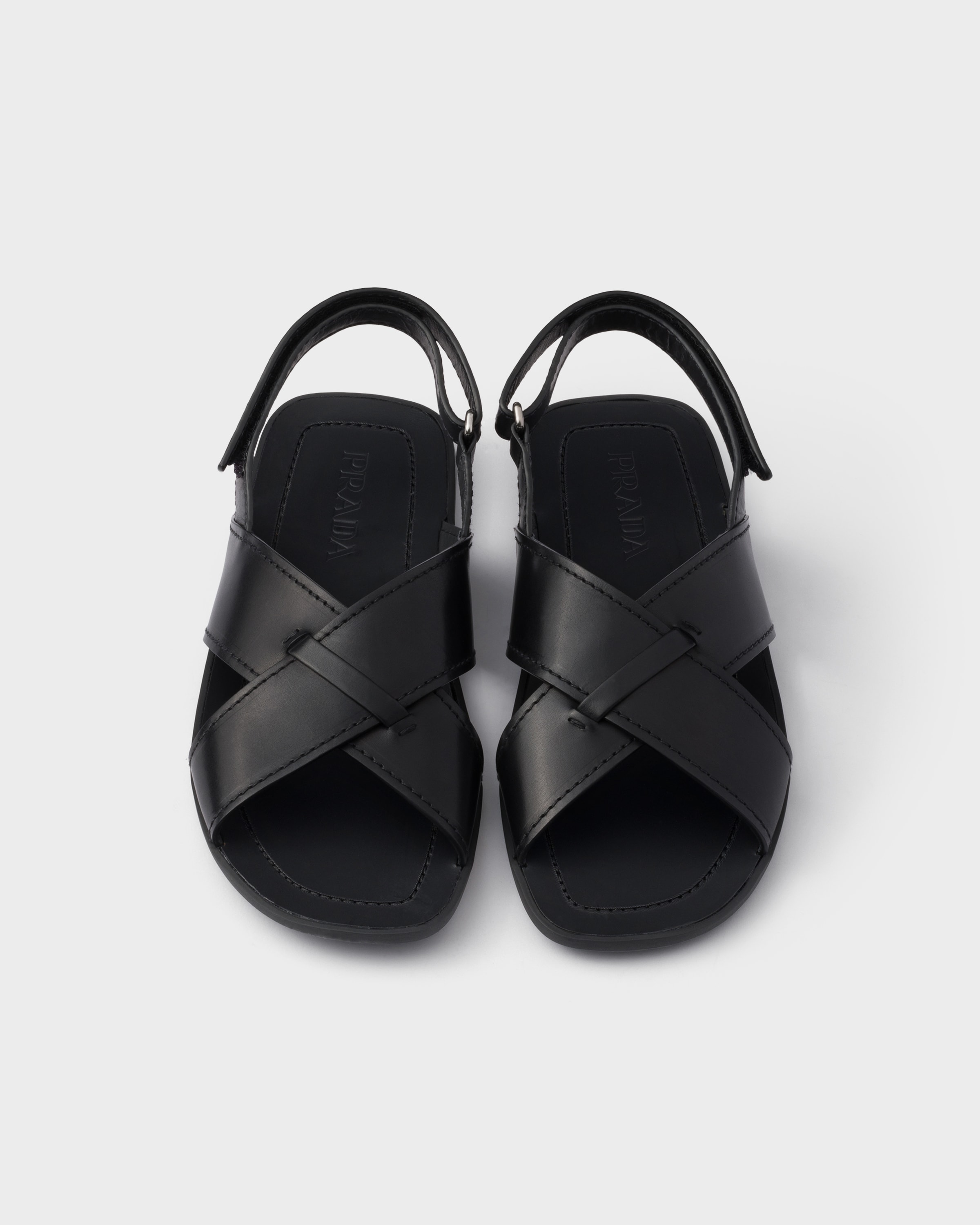 Black Decò leather crisscross sandals | PRADA
