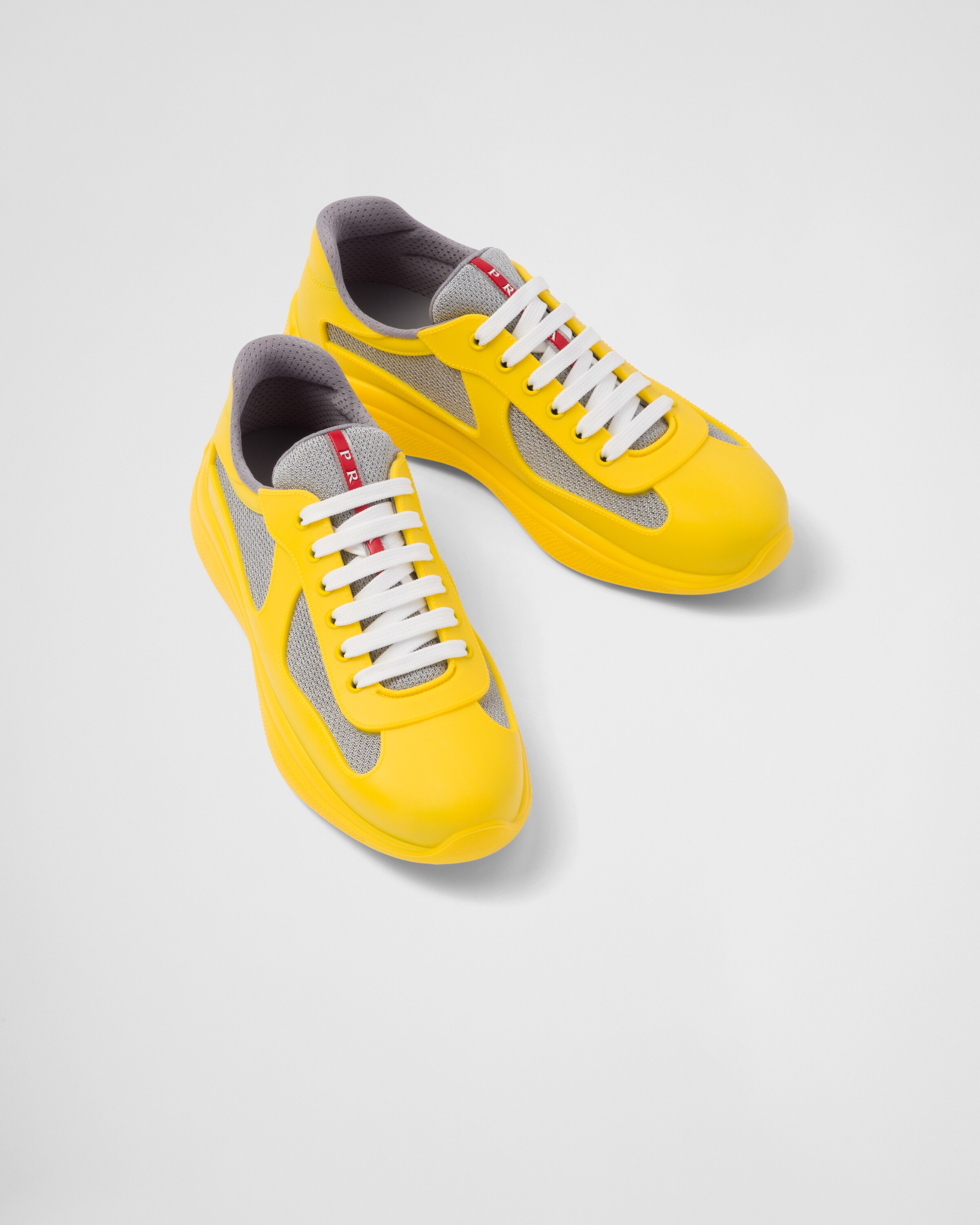 Yellow and shop black prada sneakers