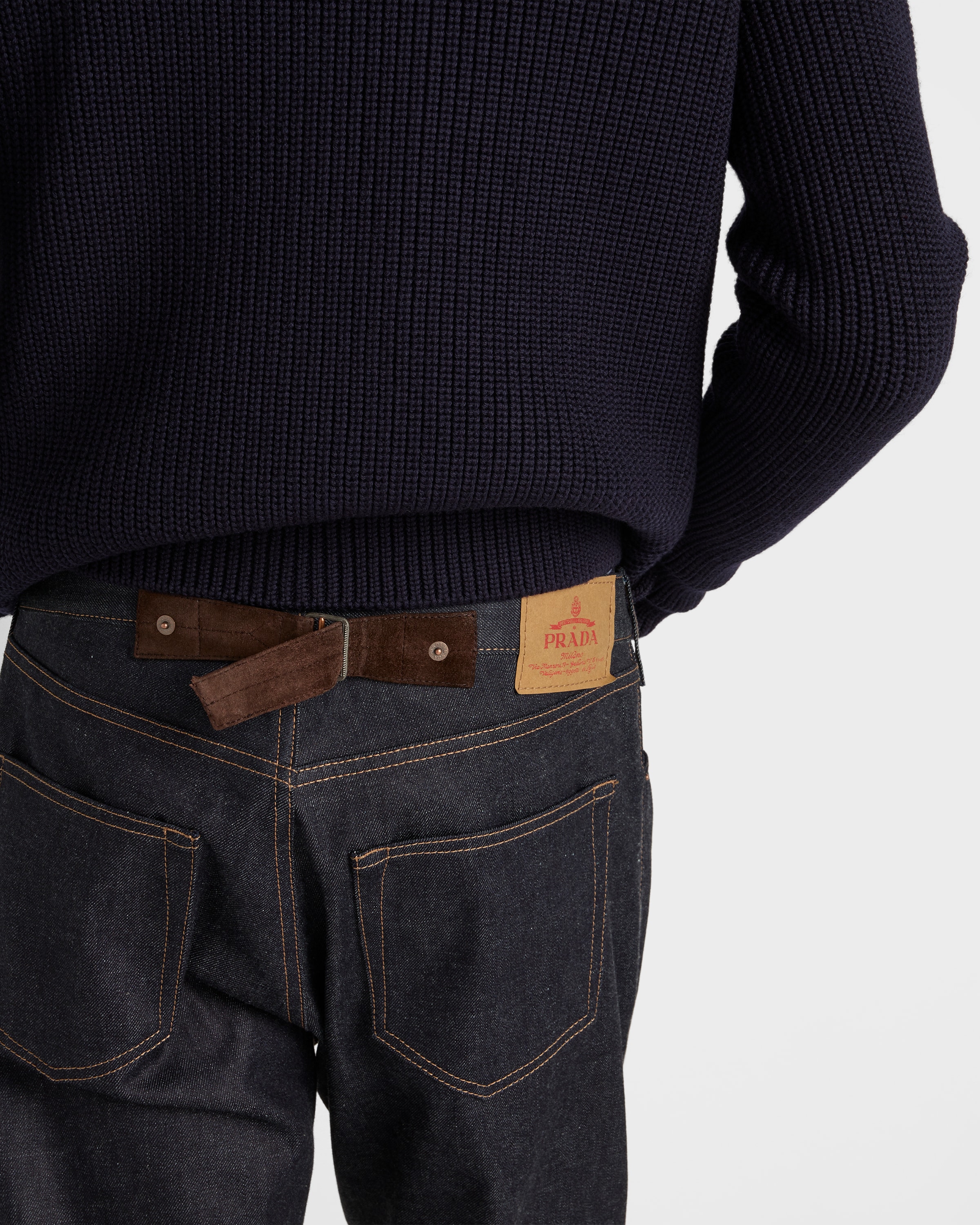 Raw denim jeans with leather strap
