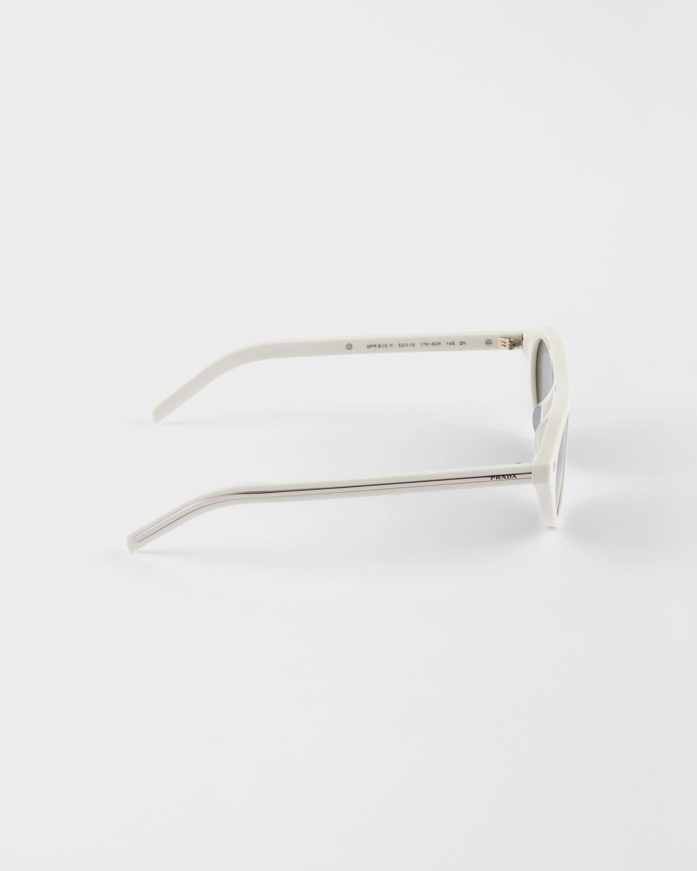 PRADA PRADA SUNGLASSES WITH THE ICONIC METAL PLAQUE