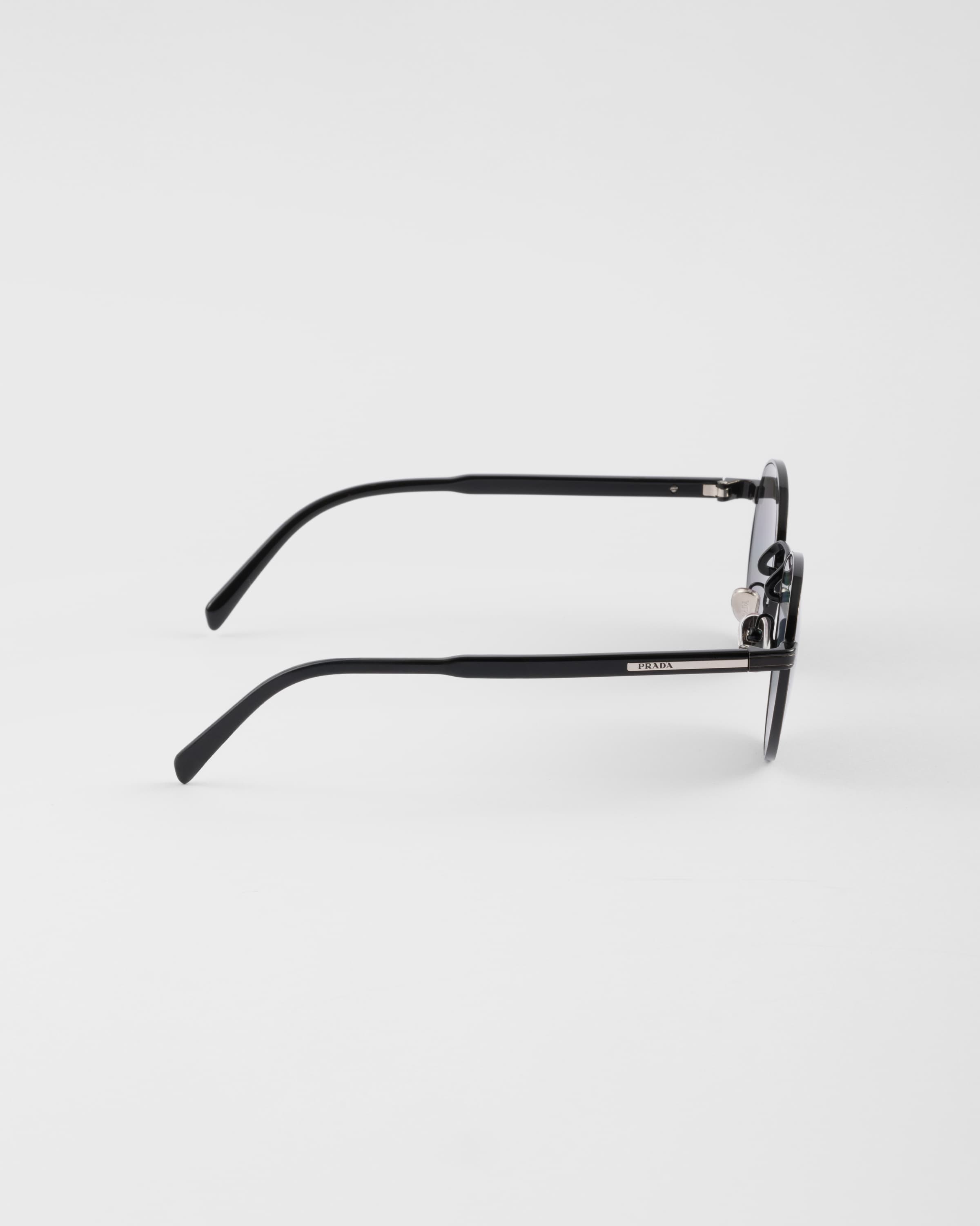 PRADA SUNGLASSES WITH THE ICONIC METAL PLAQUE