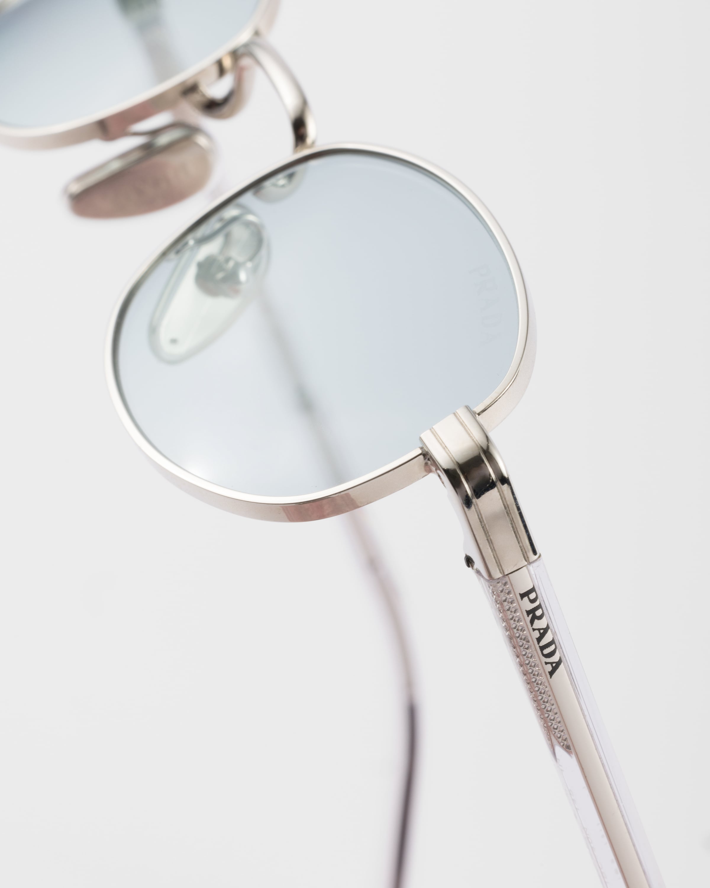 PRADA SUNGLASSES WITH THE ICONIC METAL PLAQUE