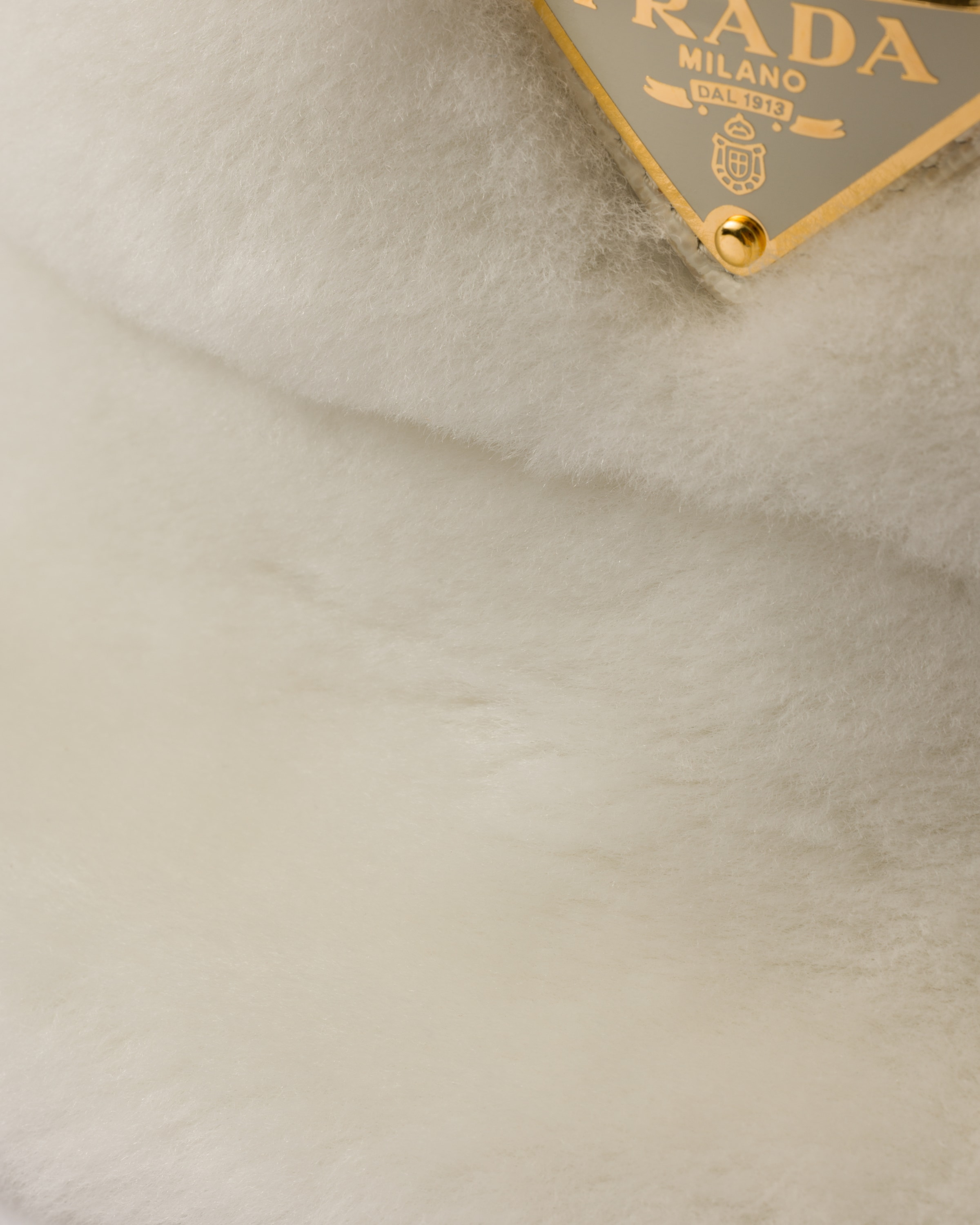 Prada Triangle-logo Shearling Bucket Hat In Weiss