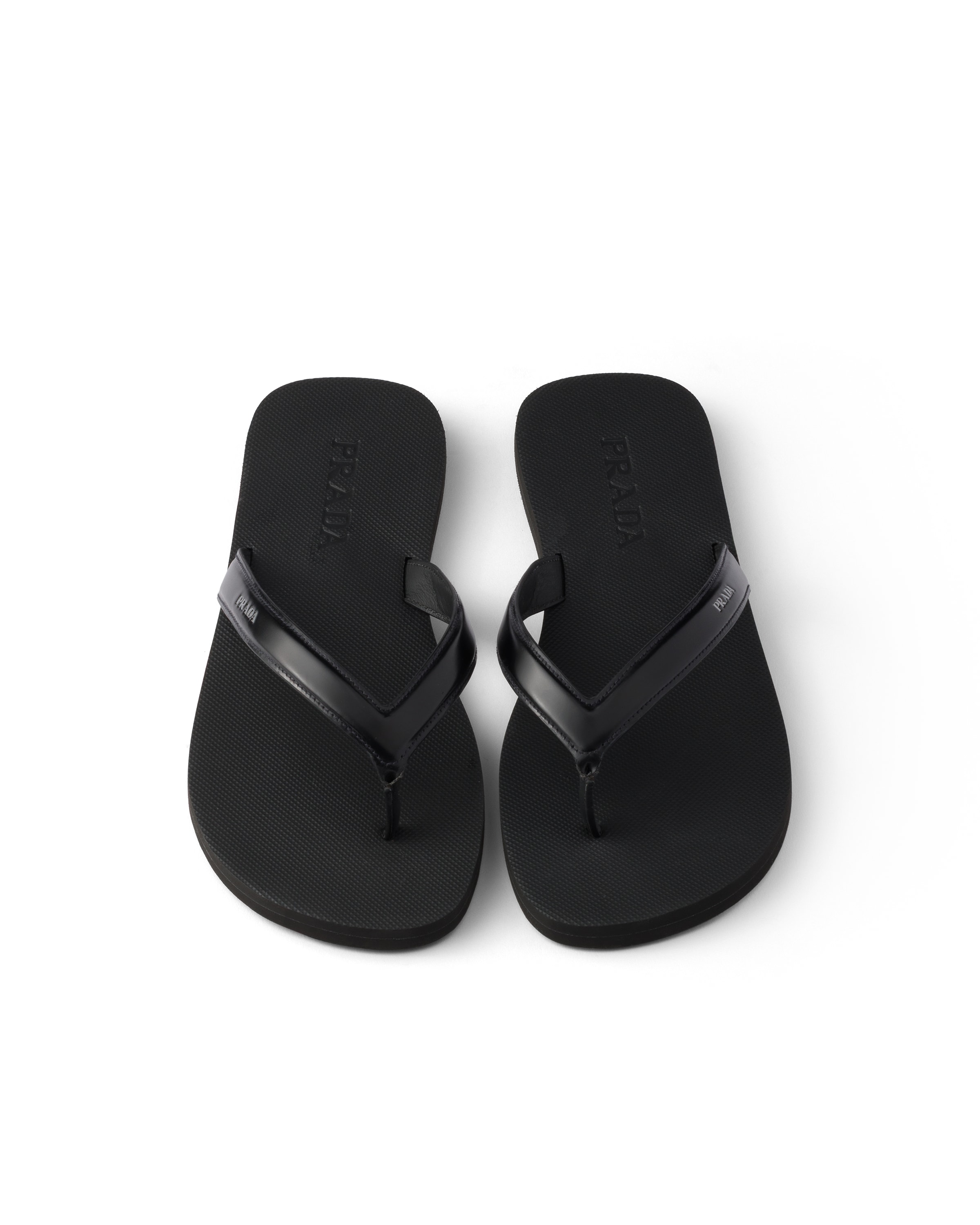 Prada Logo Embossed Leather Flip Flop Sandals In Black